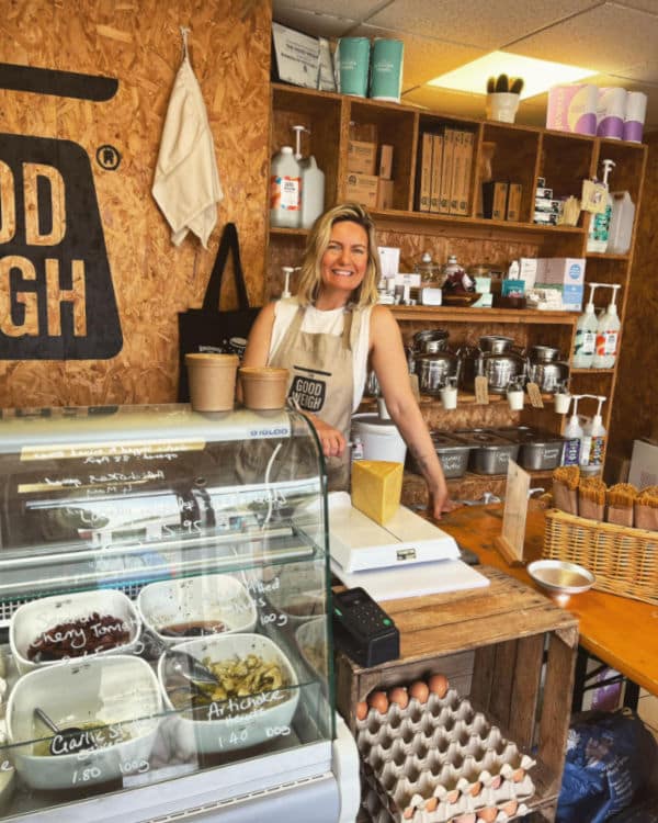 Shopkeeper behind the counter of The Good Weigh in Nottingham