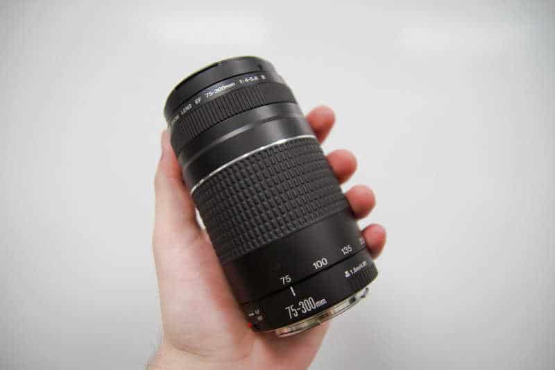 Person holding a camera lens.