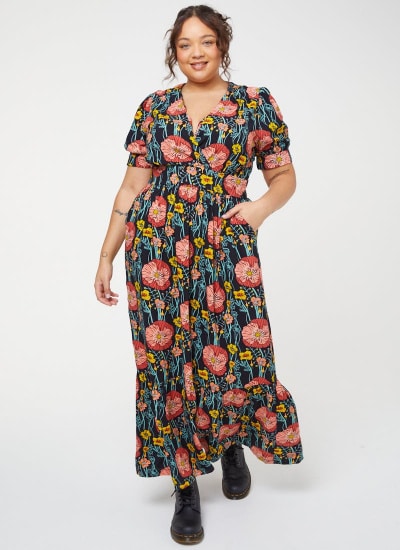 Person wearing a floral maxi dress from Joanie clothing.