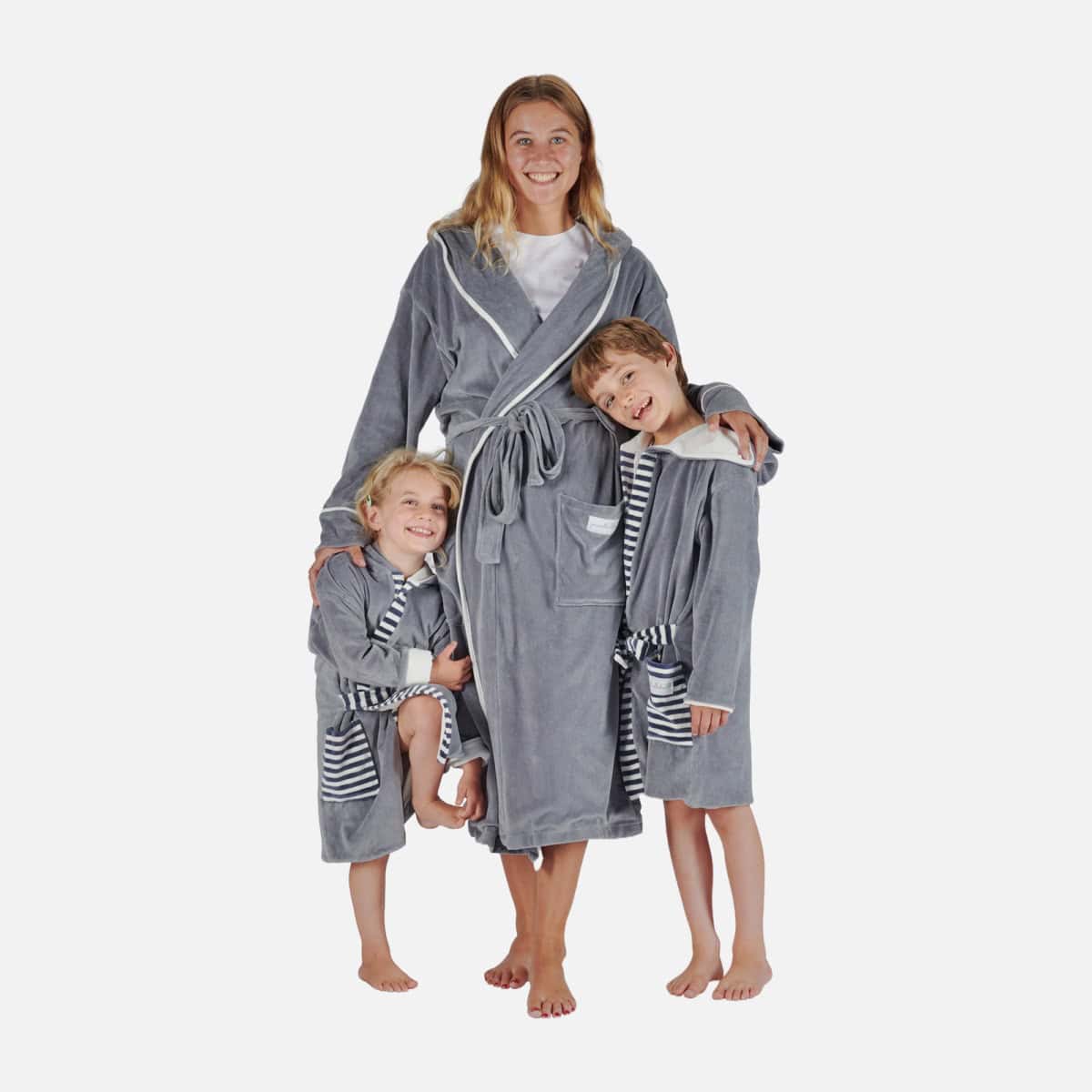 Adult wearing a grey Pure Earth Collection dressing gown, cuddling two children in matching grey robes.