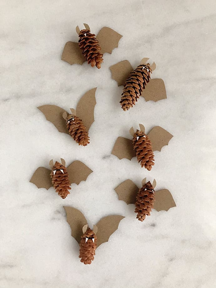 Eco-friendly Halloween bat decorations made from pinecones and cardboard