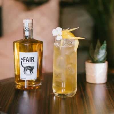 bottle of fairtrade gin next to a cocktail