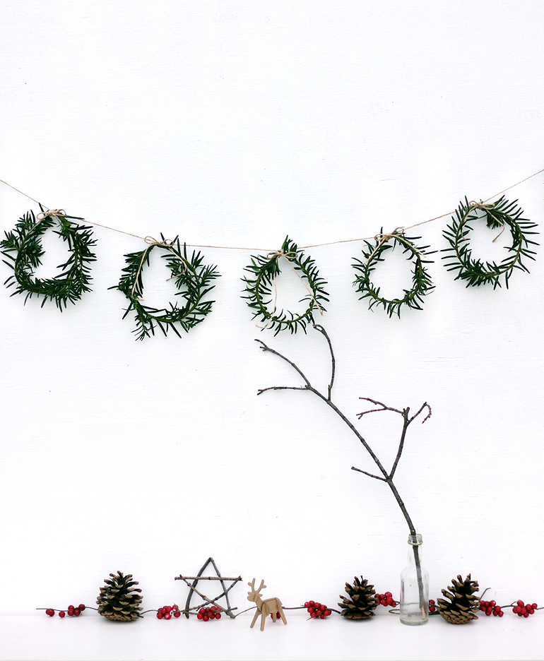 Plastic-free rosemary garland on a white wall