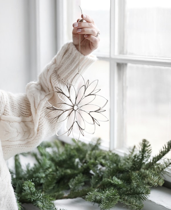 Person holding a Christmas star made from old toilet roll tubes