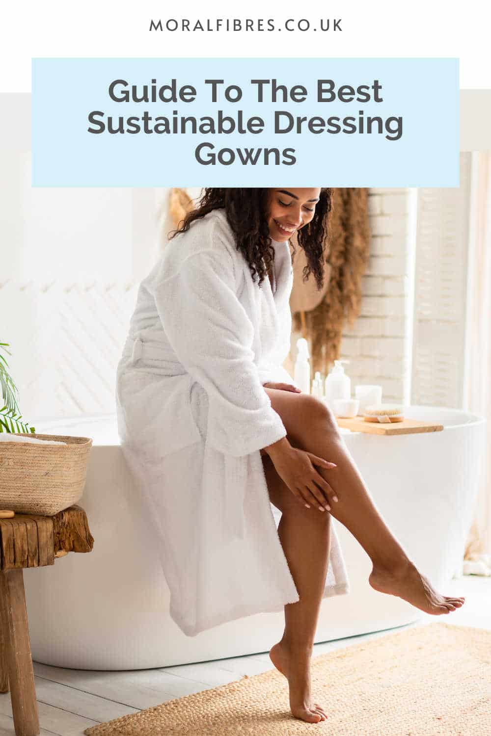 Person sitting on the side of a bath in a white robe, with a blue text box that reads guide to the best sustainable dressing gowns.